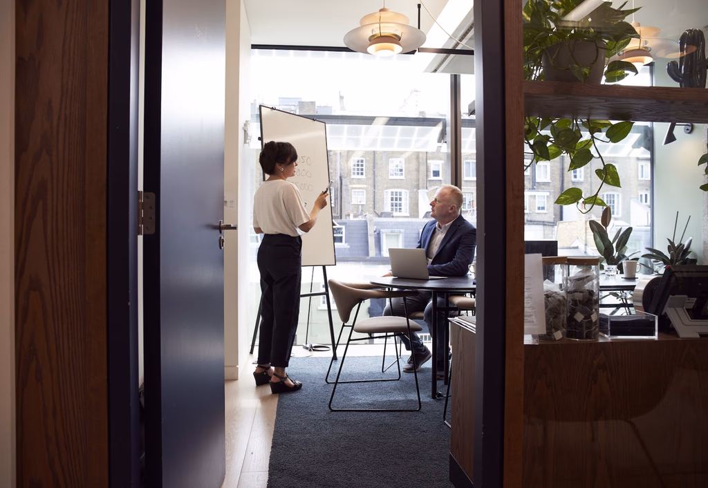 Colleagues discussing work in an office